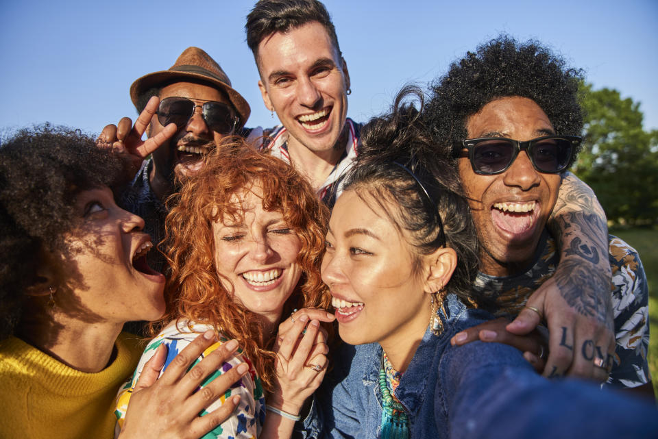 A group of friends feels happy. (Getty Images)